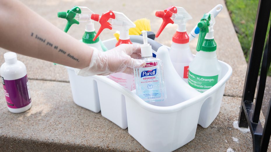 Woman Inspecting Germ-X And Cleaning Products