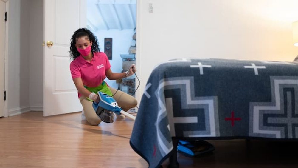 Better Life Maids cleaning professional cleaning under a bed at a St. Charles home