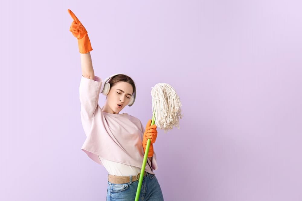 Woman Having Fun While Cleaning