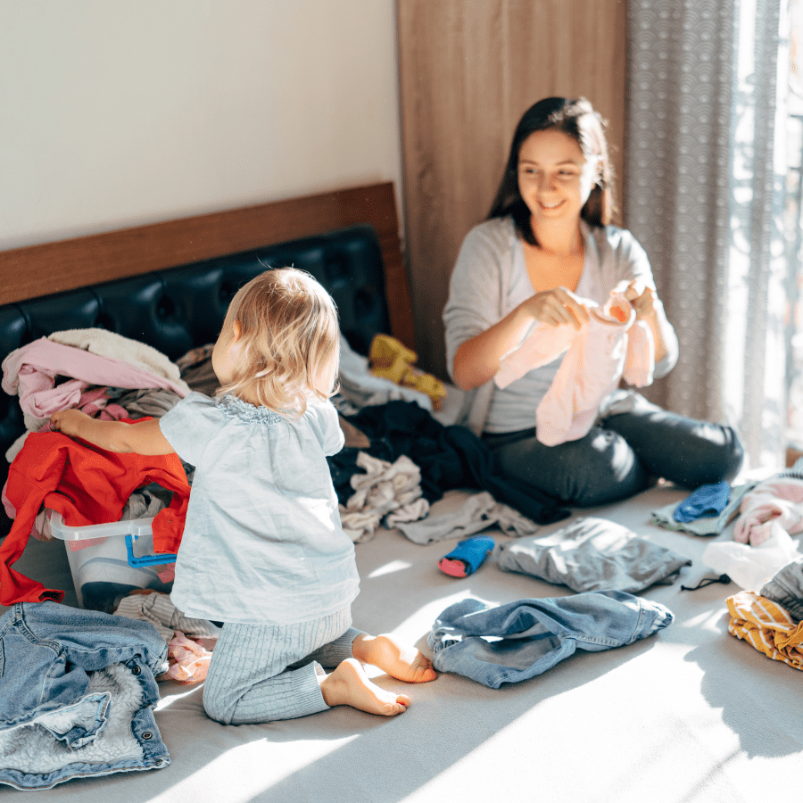 mother and daughter folding laundry as a family 