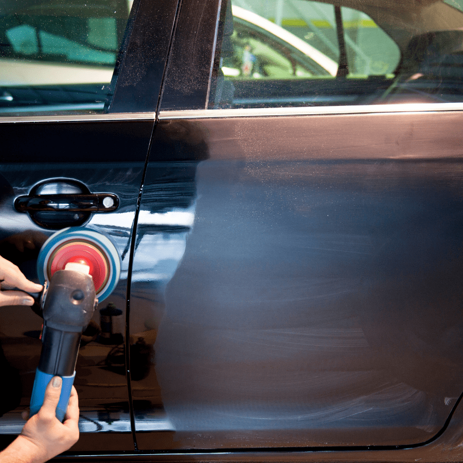 professional buffing wax onto a car
