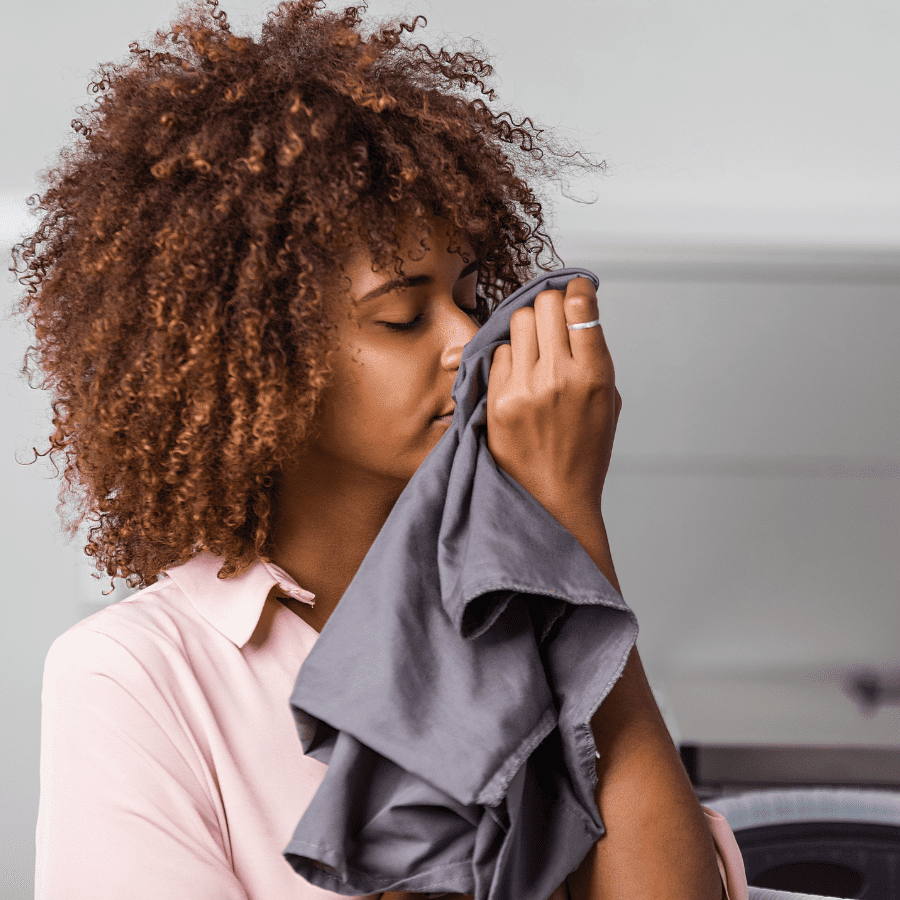 woman smelling fresh clean laundry 