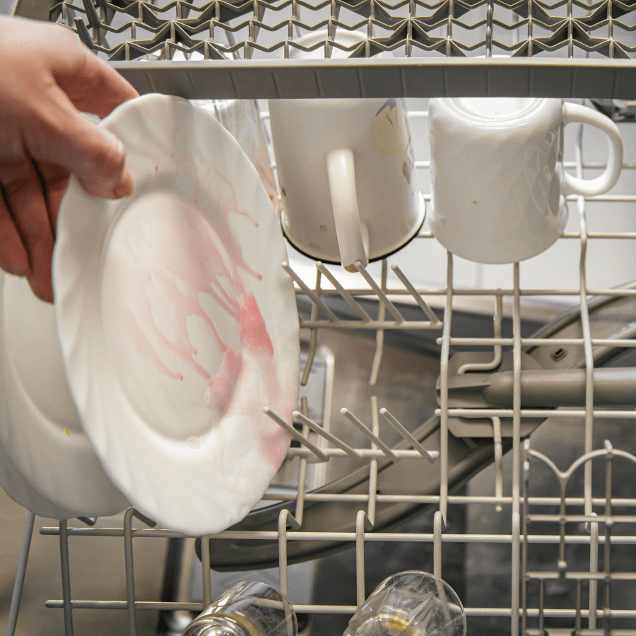 loading a dishwasher with dirty dishes 