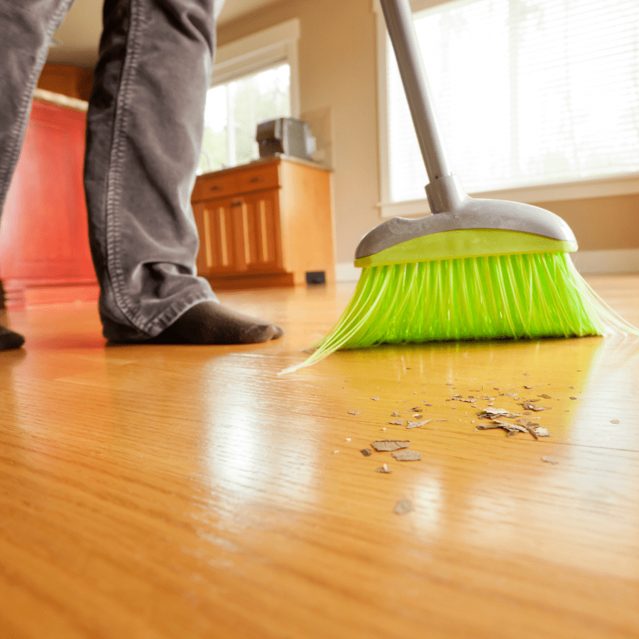 sweeping dust and debris from a hardwood floor